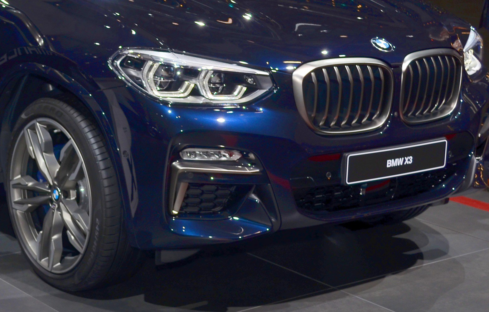 Close-up of front grille, LED headlight, and alloy wheel of an SUV