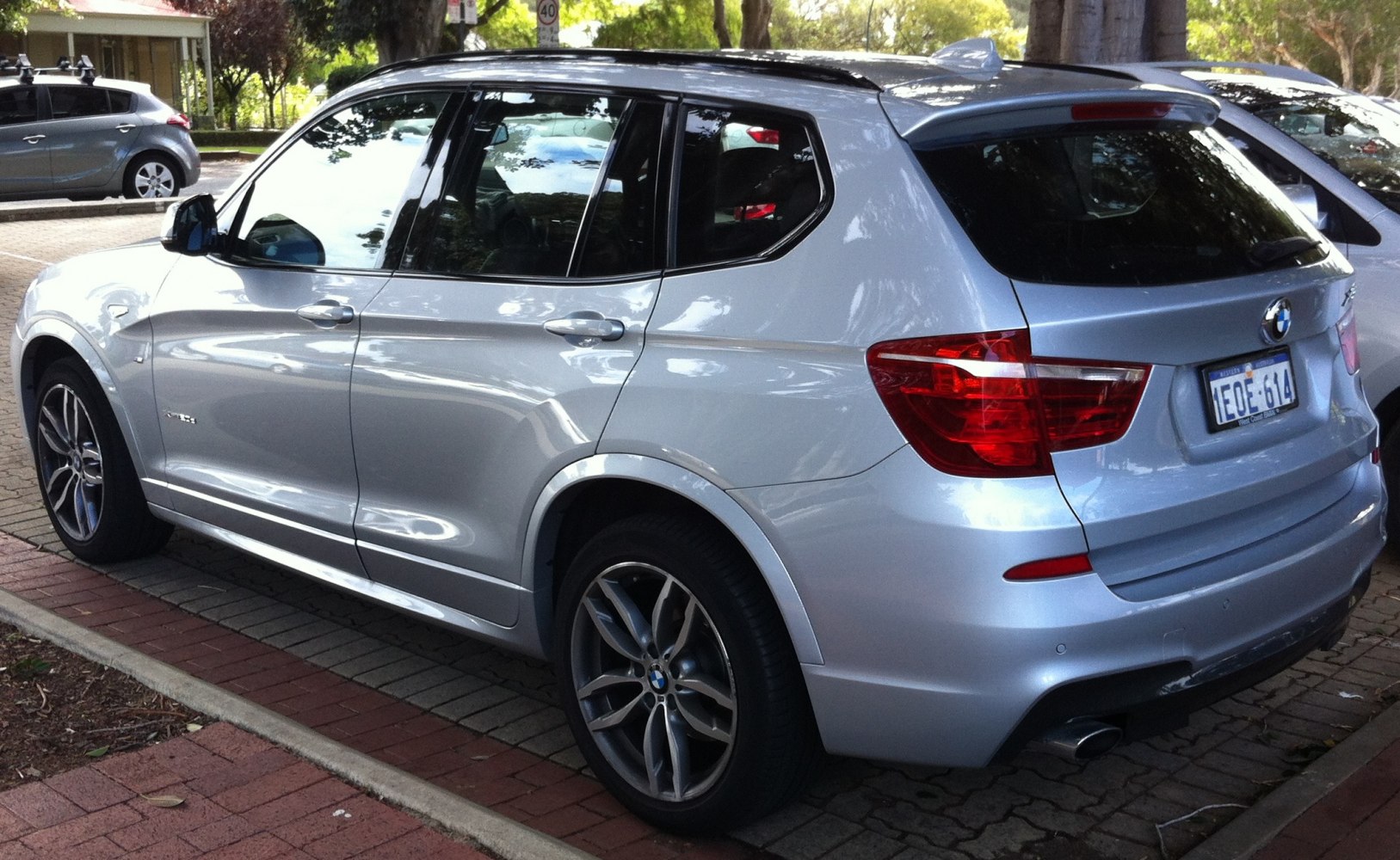 Rear side view of a silver mid-size SUV with alloy wheels and distinct taillights