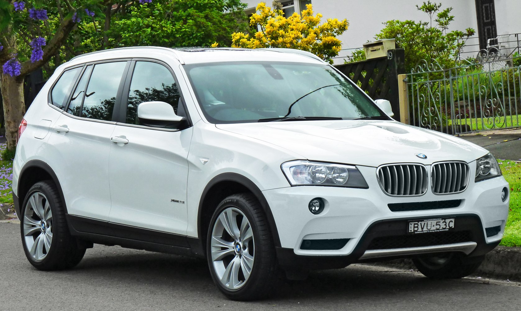White SUV showing front side view with kidney grille and alloy wheels