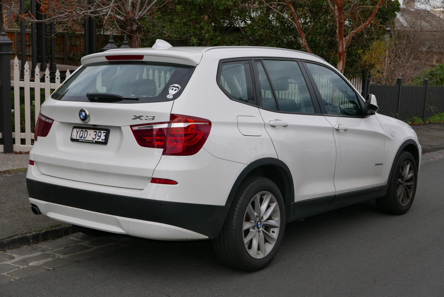 Rear and side profile of white SUV with distinctive tail lights and alloy wheels