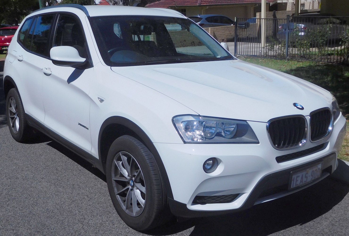 Front side view featuring dual headlights and kidney grille