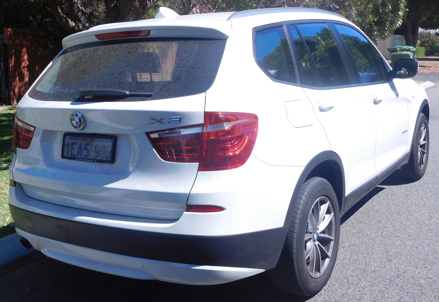 Rear and side view of a white SUV featuring distinctive taillights and alloy wheels