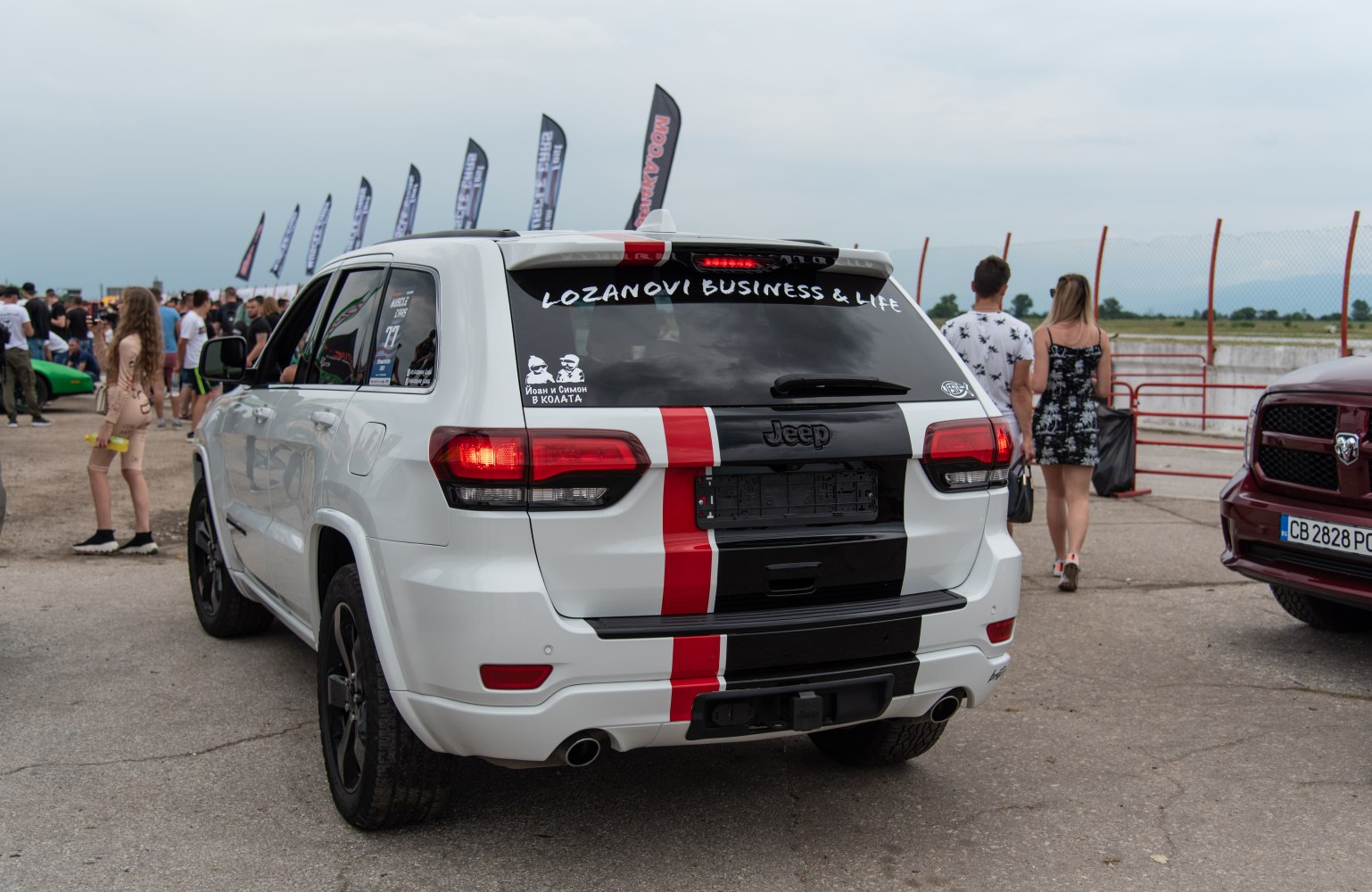 Rear view of SUV with black and red racing stripes
