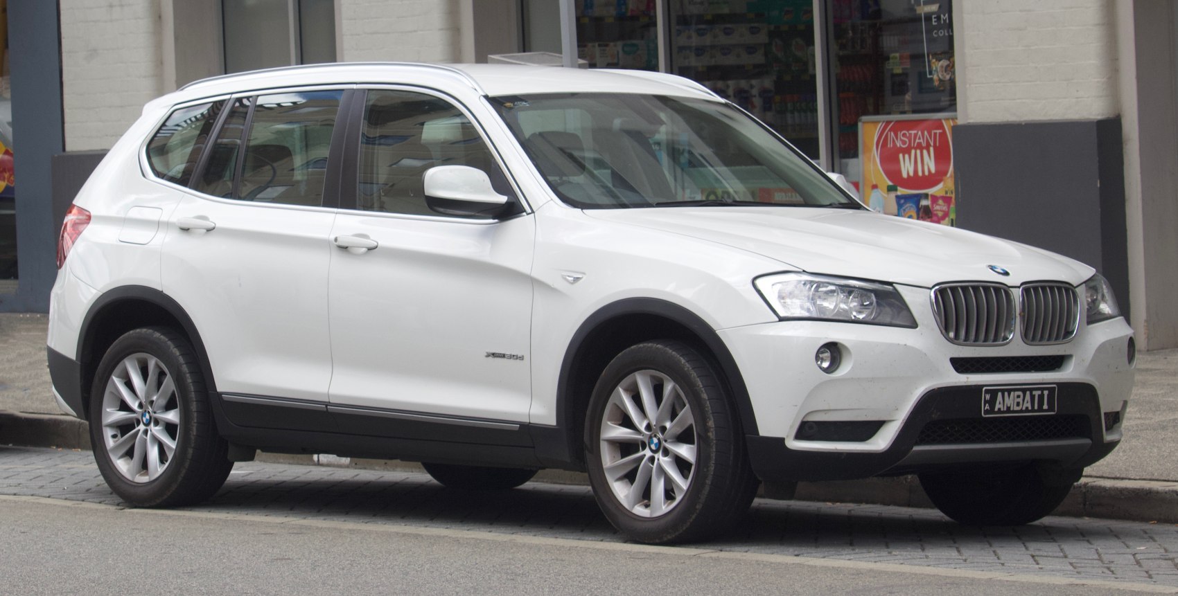 White SUV with kidney-shaped grille and alloy wheels