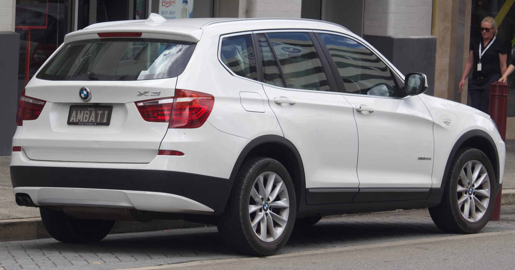 Rear and side view of white SUV with alloy wheels and tinted windows.