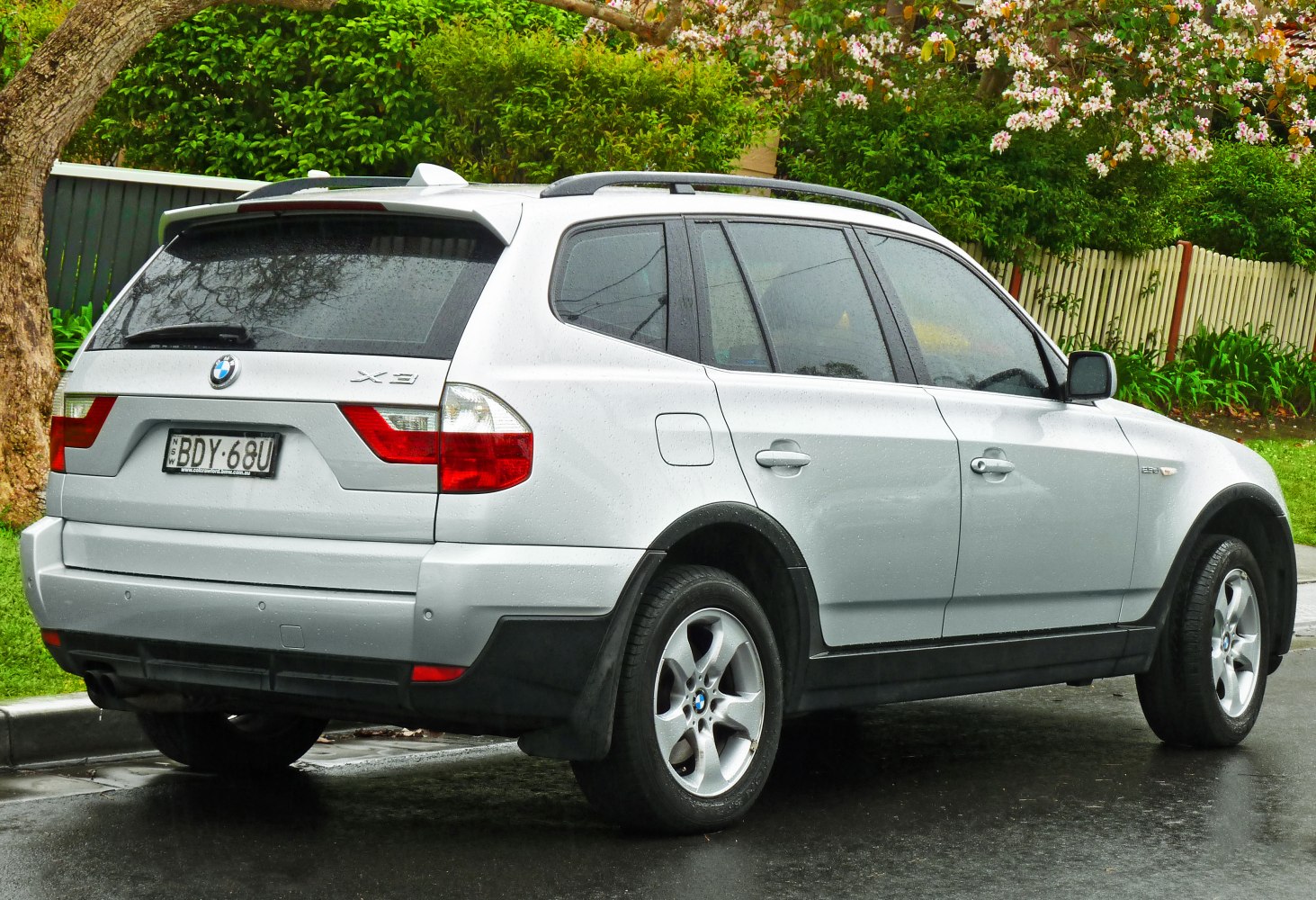 Rear and side view of silver SUV with distinctive taillights and alloy wheels