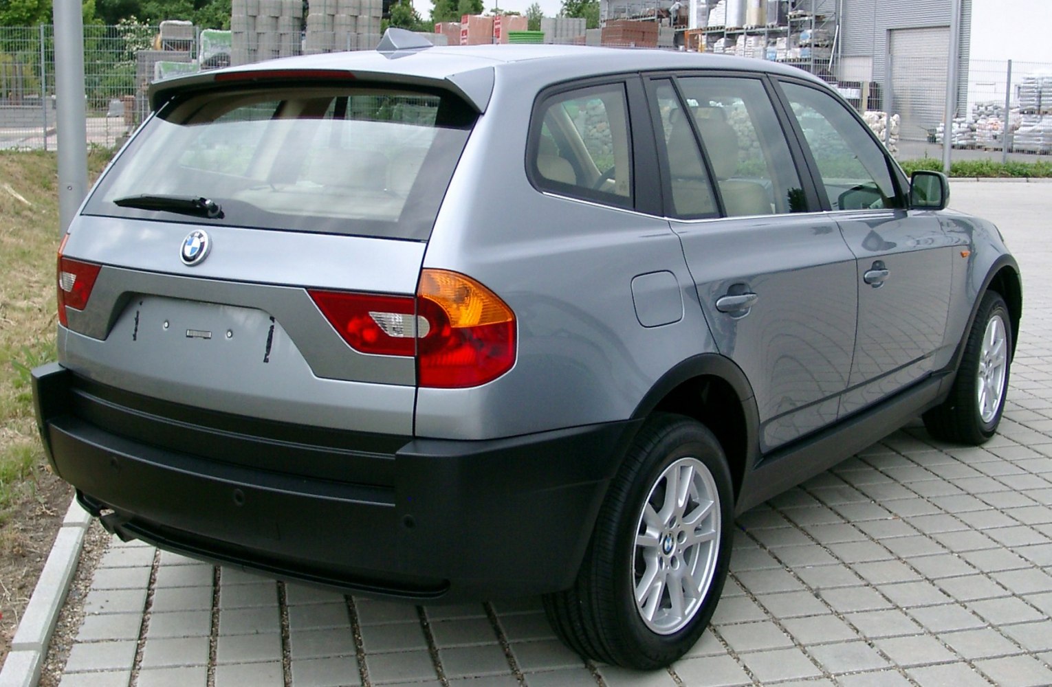 Silver SUV rear with black lower trim and alloy wheels