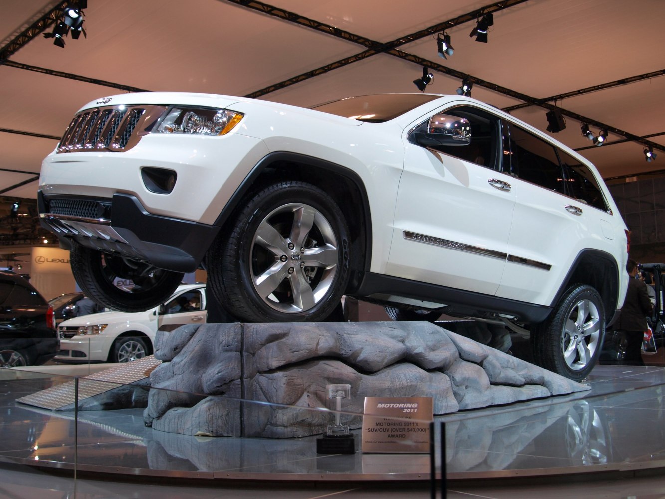 White SUV on rugged rock display with off-road features