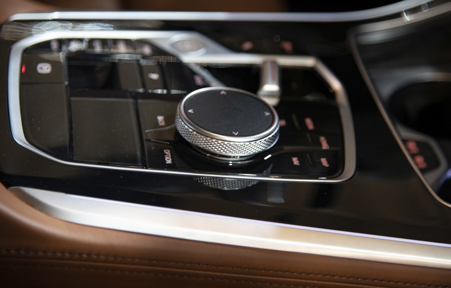 Rotary control knob on center console with buttons