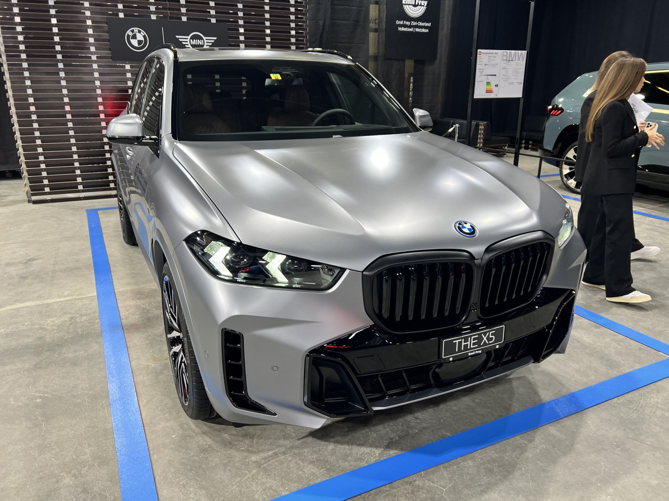 Front view of BMW SUV with matte finish and distinctive headlights