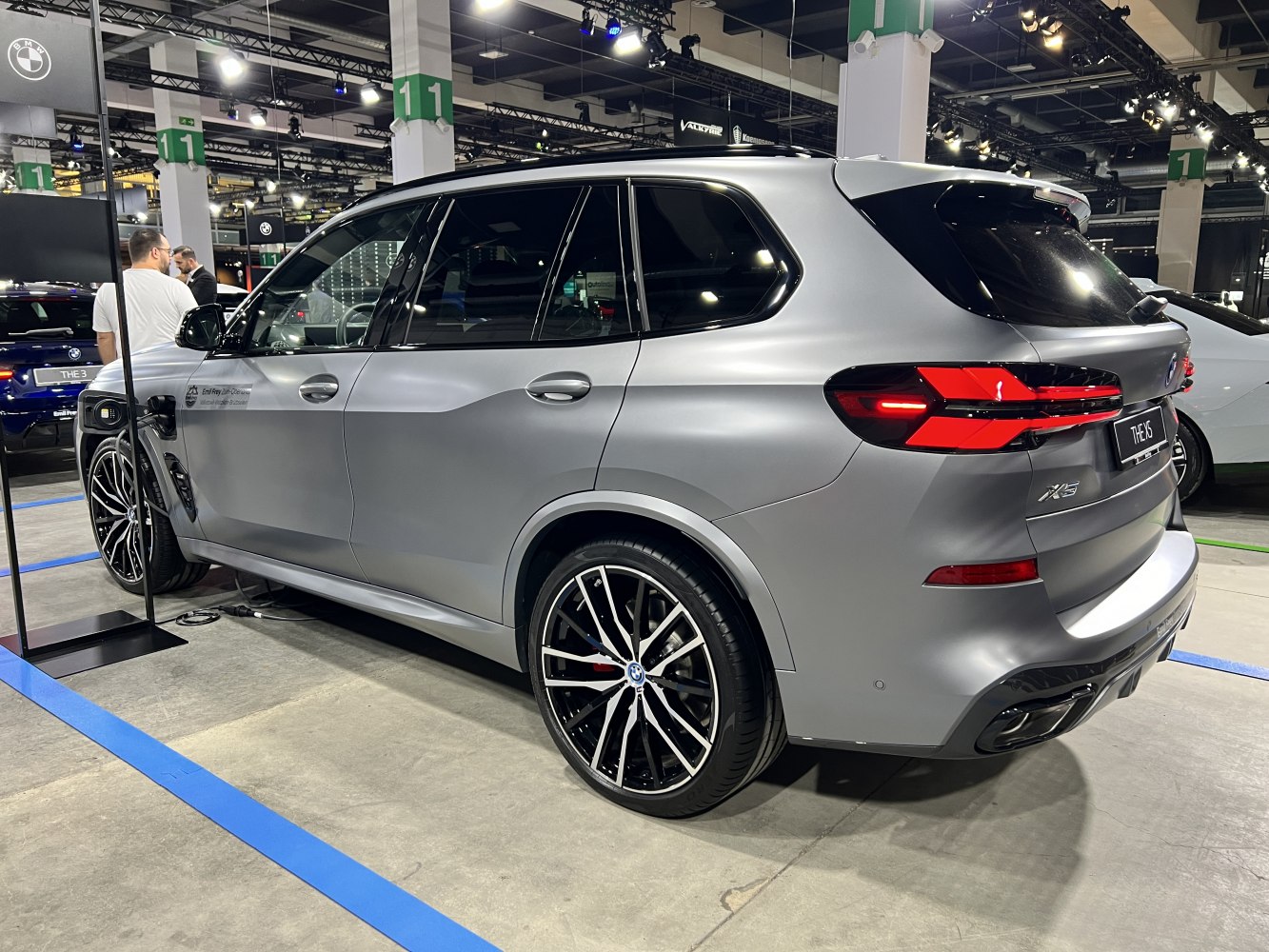 Silver SUV rear side with modern taillights and alloy wheels in exhibition setting