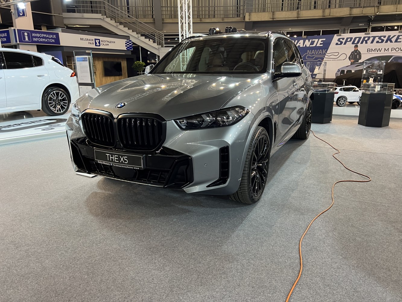Front view close-up with bold black kidney grill and sleek headlights.
