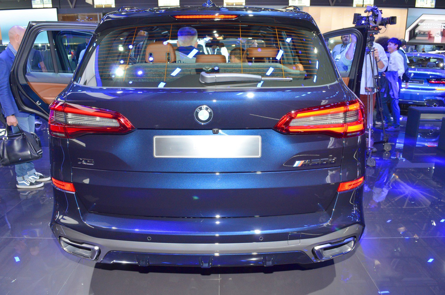 Rear view of an SUV with LED taillights and dual exhaust tips.