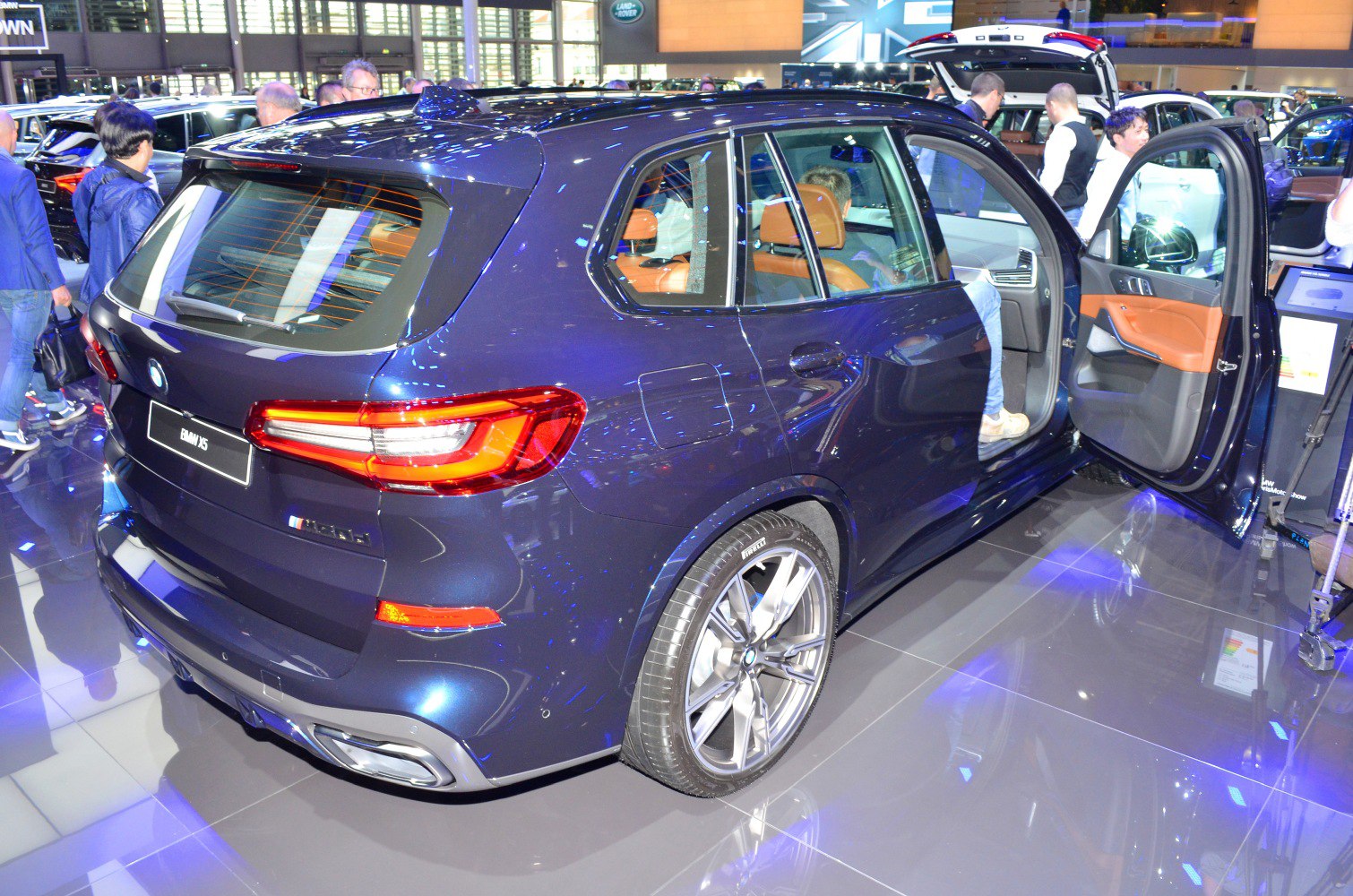 Rear view and open rear door showing luxury SUV interior