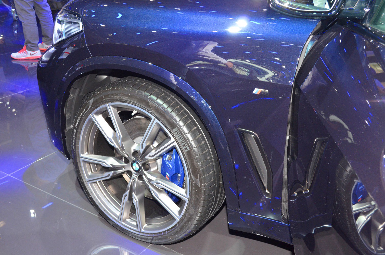 Close-up of front alloy wheel with blue M Sport brake caliper