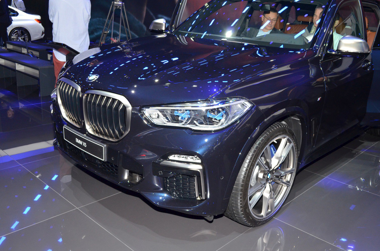 Close-up of car front with kidney grille, LED headlights, alloy wheels