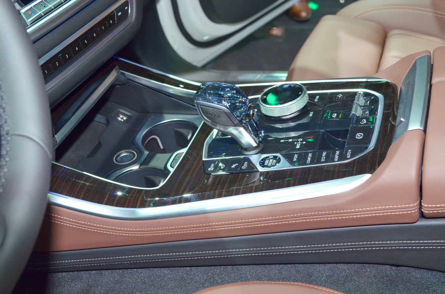 Luxury gear shifter and multifunction control dial on wood-panel center console