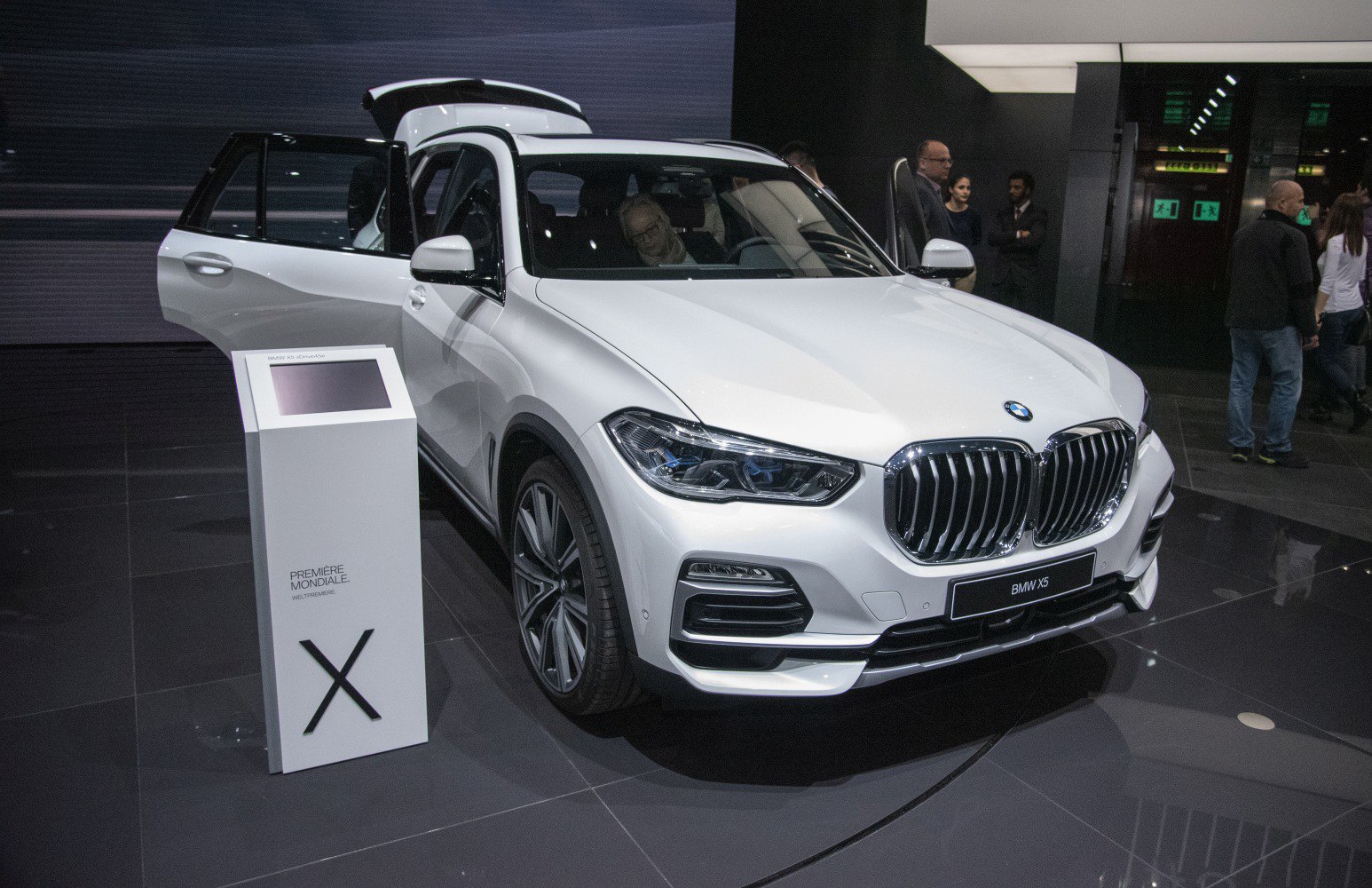 Front view of SUV with kidney grille and open front and rear doors
