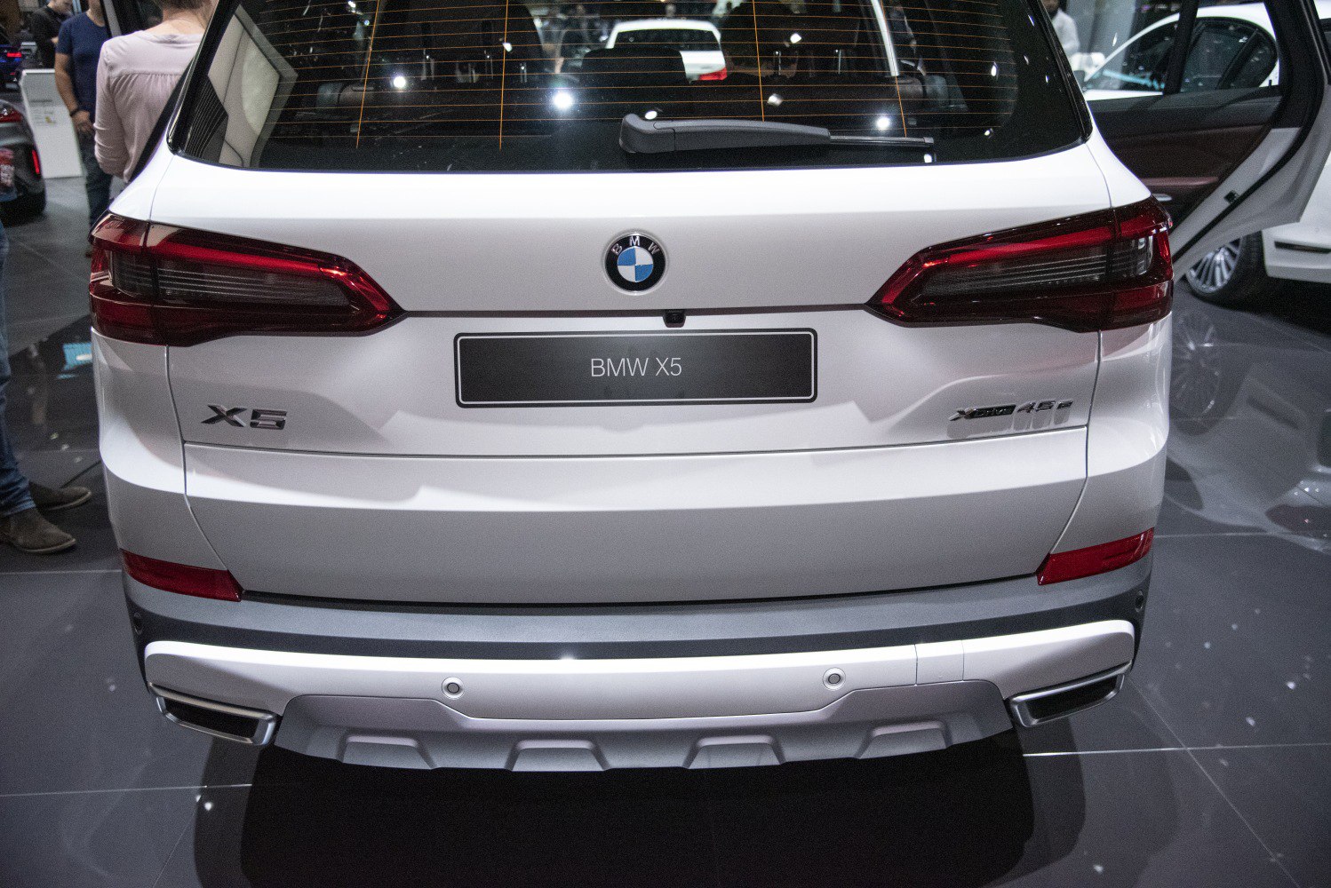 Rear view with BMW badge, tail lights, and dual exhausts