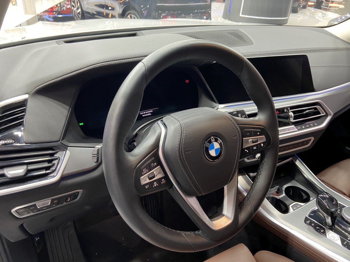 Steering wheel and dashboard with controls in a modern SUV interior