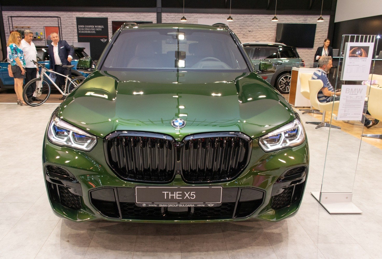 Front kidney grille and LED headlights of green luxury SUV