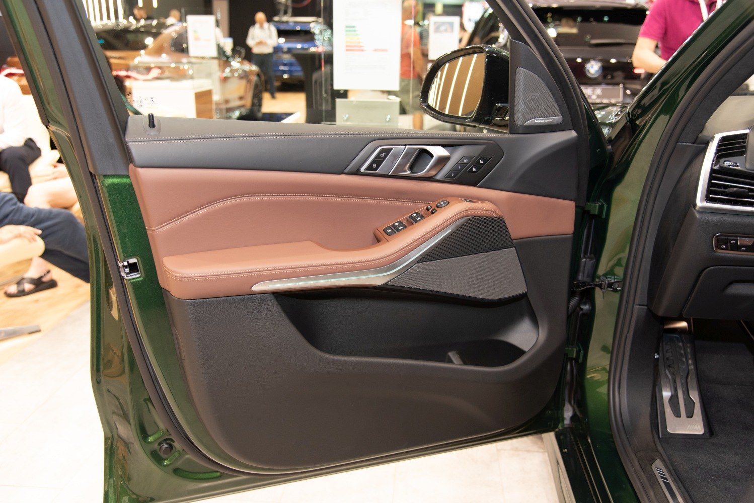 Luxury SUV interior door panel with ergonomic controls and premium trim.