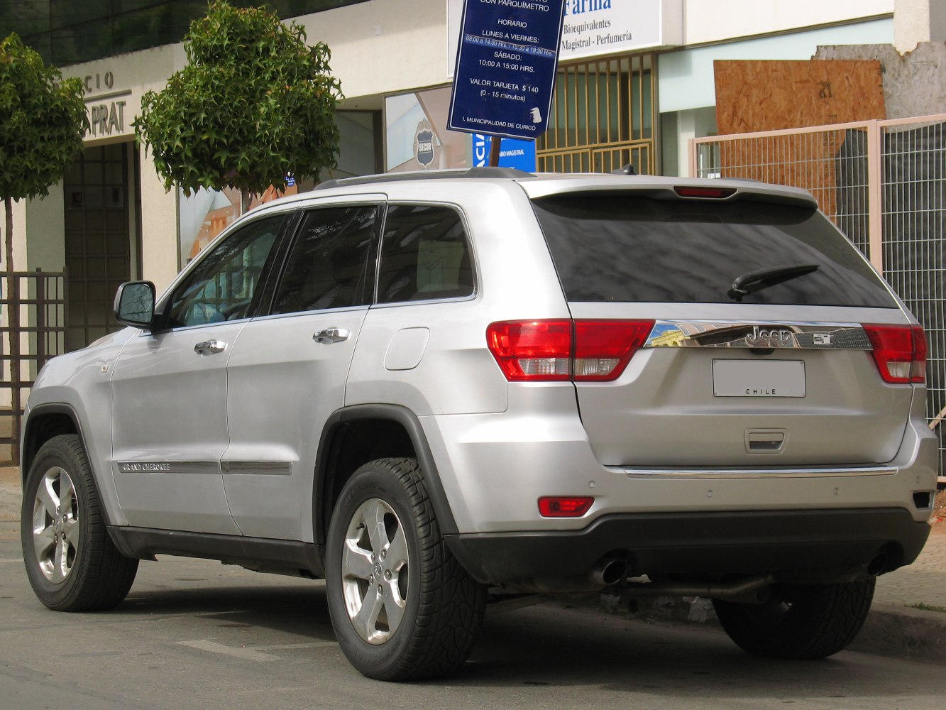 Rear and side view of silver SUV with alloy wheels and tinted windows