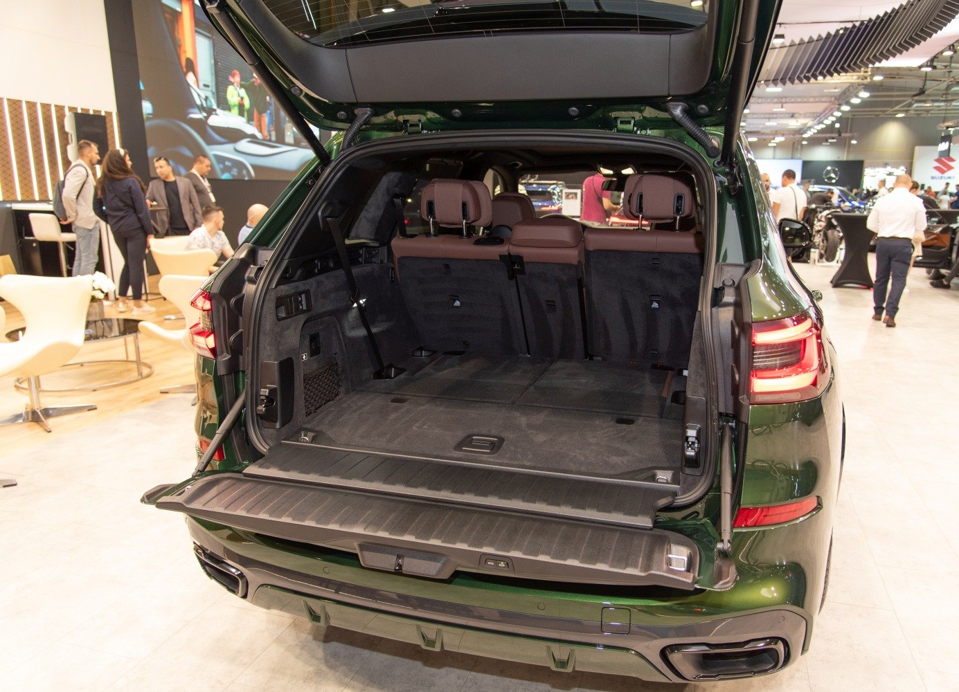 Spacious open trunk cargo area with brown seats and rear hatch open
