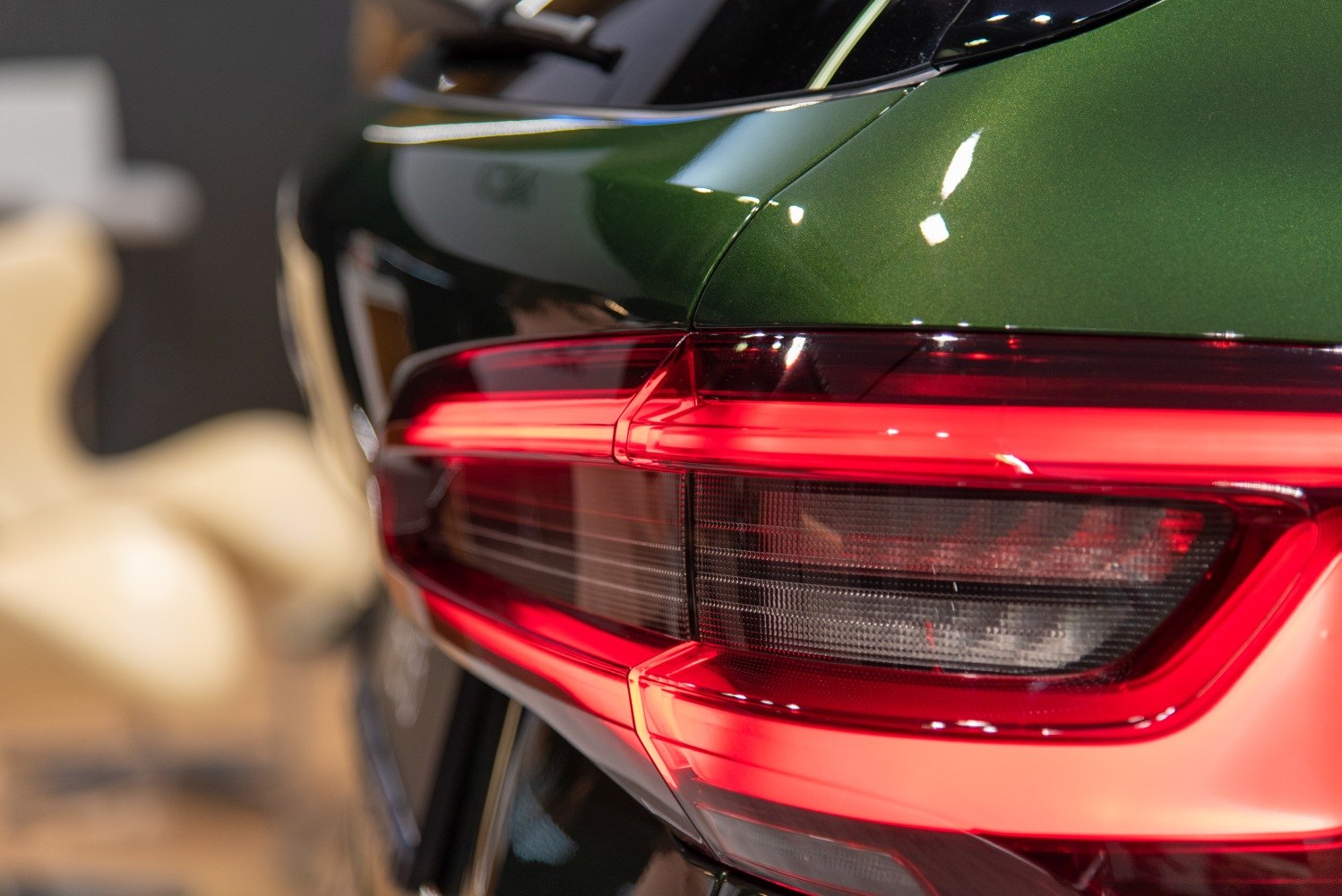 Close-up of rear LED tail light with green glossy paint