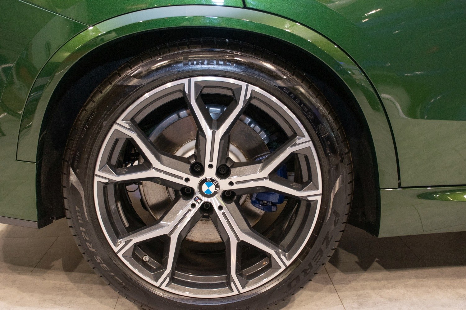 Close-up of alloy wheel with Pirelli tire and blue brake caliper