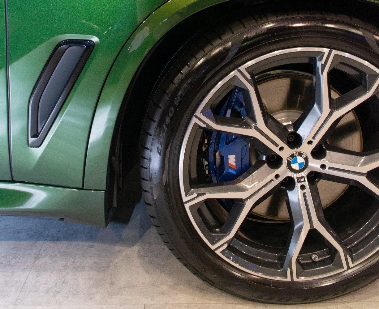M Sport alloy wheel with blue brake caliper and side vent.