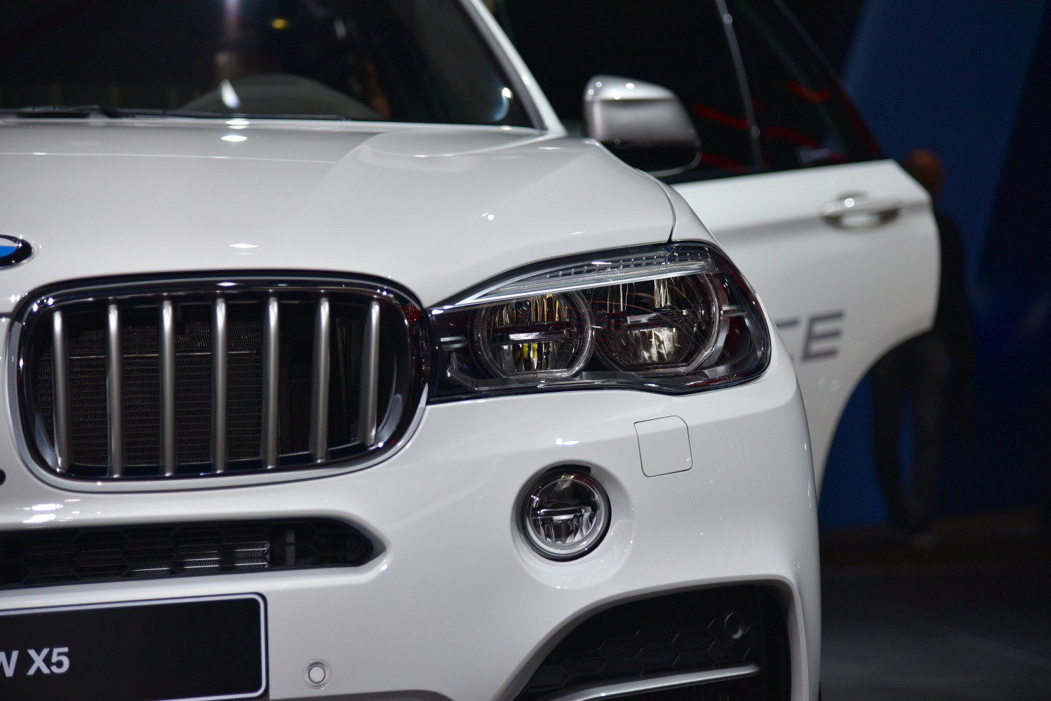 Front grille and headlight with fog light on a white vehicle