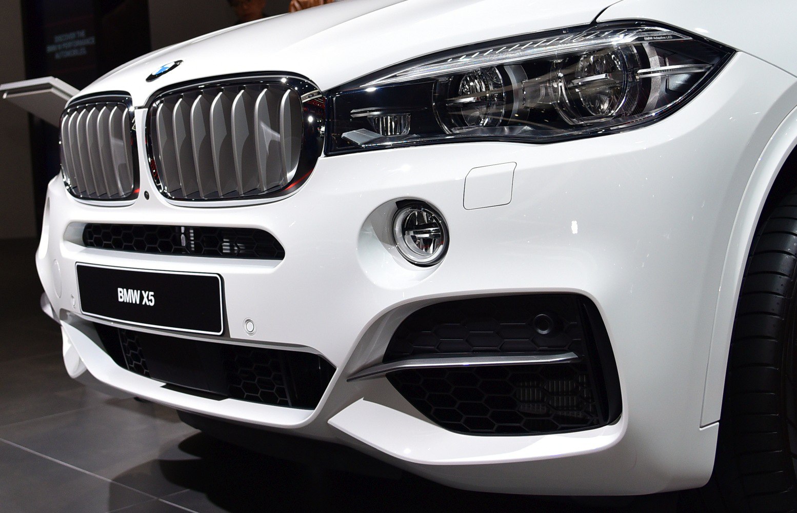 Front grille and LED headlight with fog light on white SUV