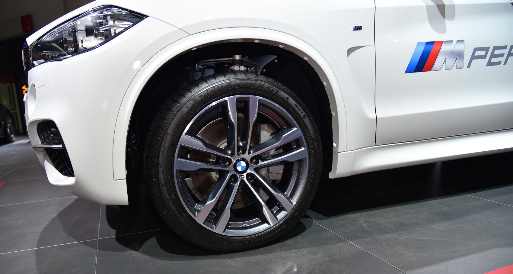 Front wheel with alloy rim and headlight, featuring M Performance styling