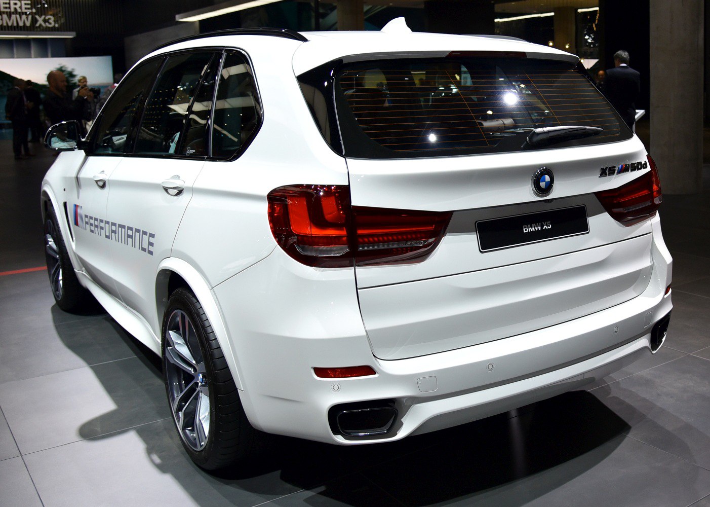 White SUV rear view with taillights, exhaust and sporty details