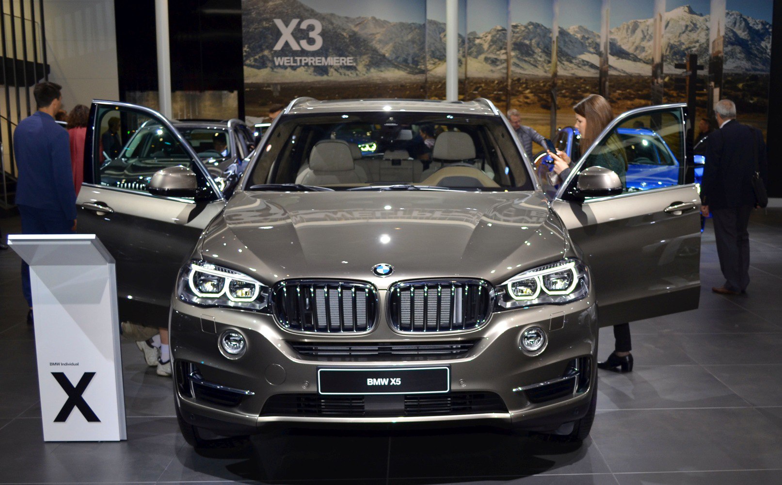 Front view of luxury SUV with kidney grille and open front doors