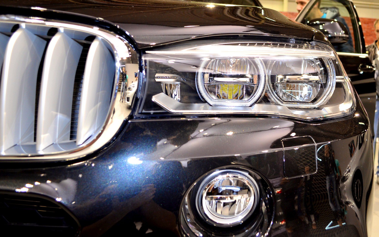 Close-up of dual LED headlights and kidney grille with fog light