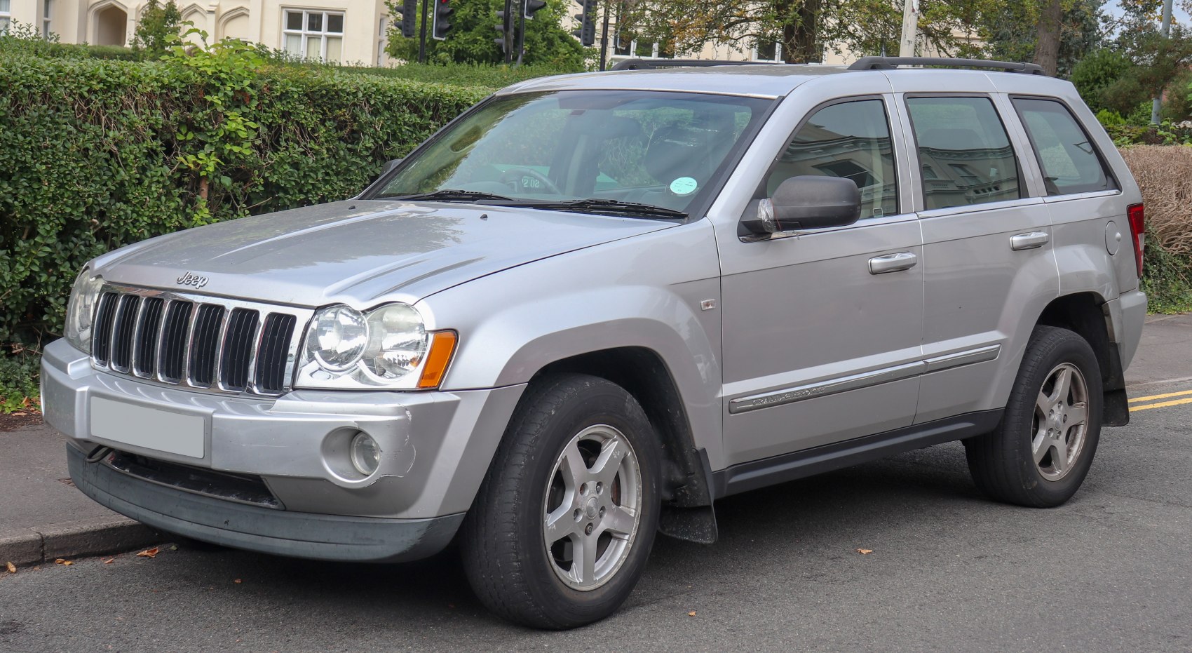 Silver SUV, front grille, headlight, side-front perspective