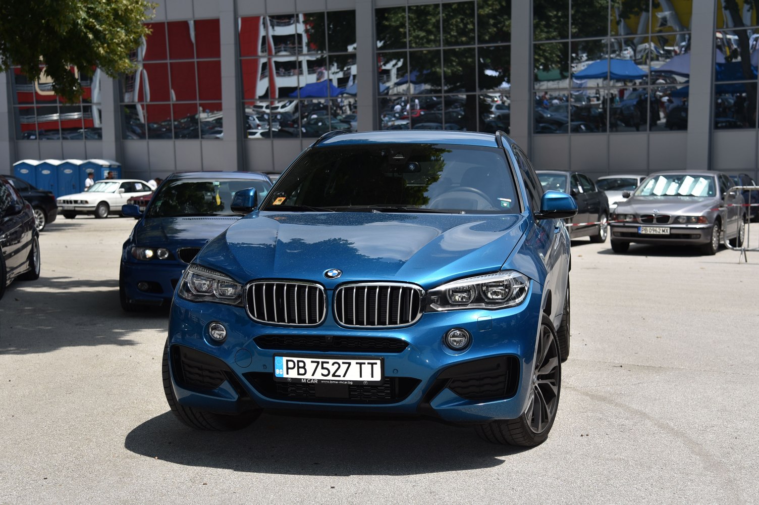 Front view of blue SUV with kidney grille and LED headlights