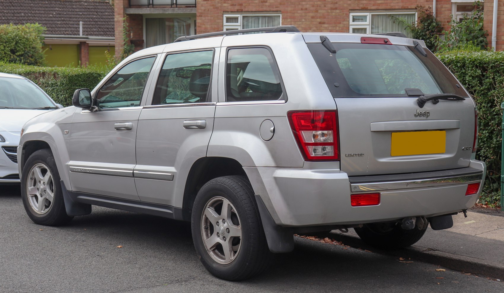 Rear side view of silver SUV with alloy wheels and rear tail lights