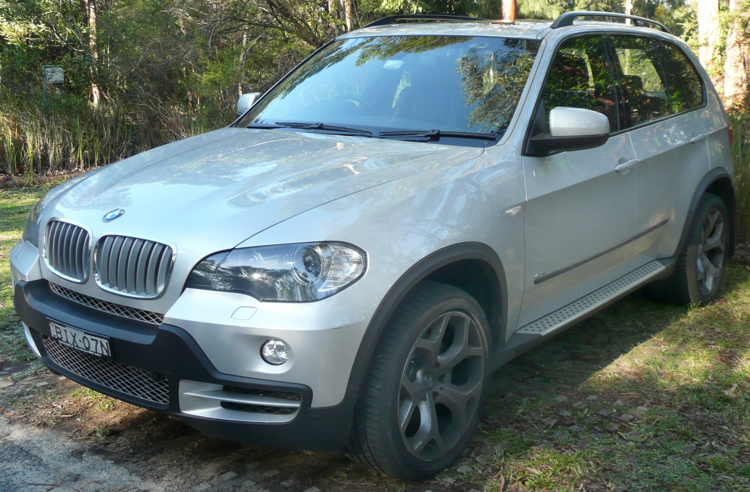 Front-side view of silver SUV with alloy wheels and roof rails