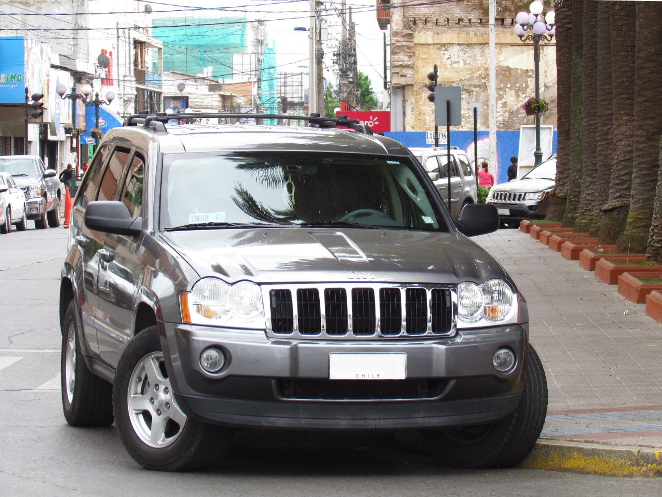Front view with iconic grille, round headlights, and roof rails