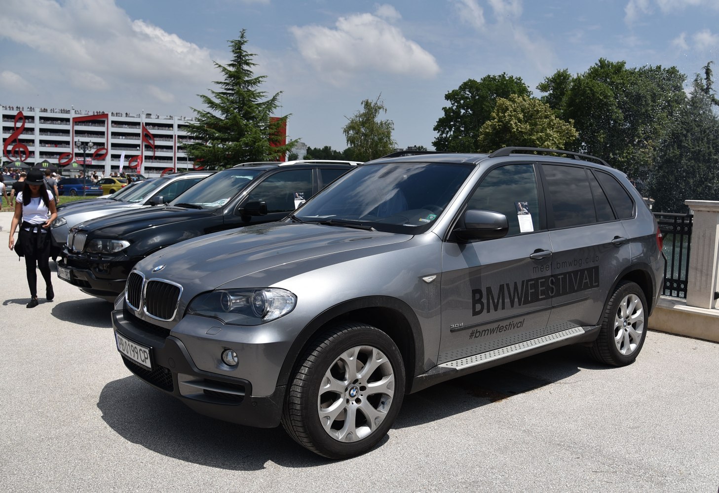 Front side view of a gray SUV with distinctive grille and wheels.