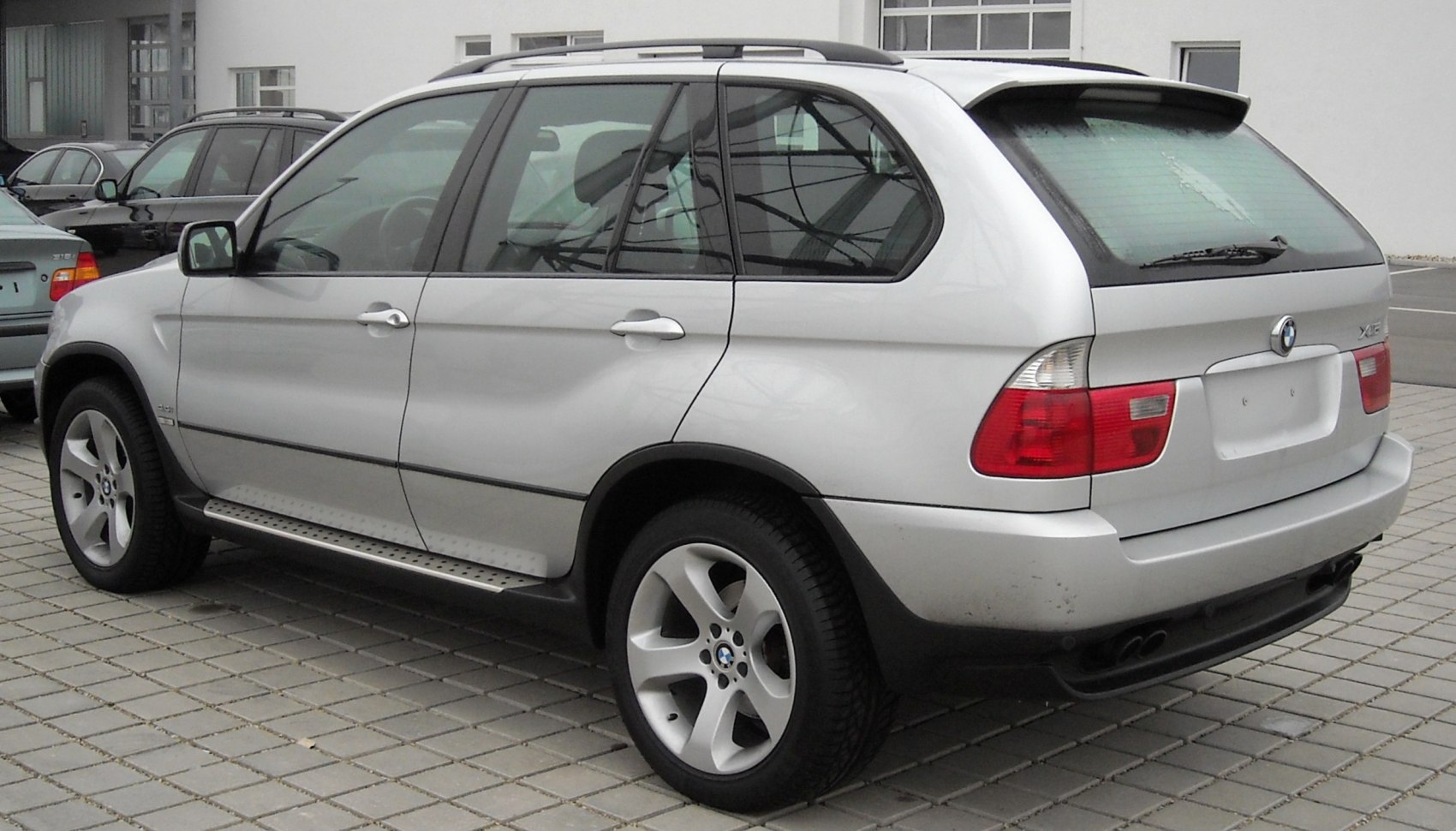 Silver SUV rear and side view with alloy wheels and roof rails