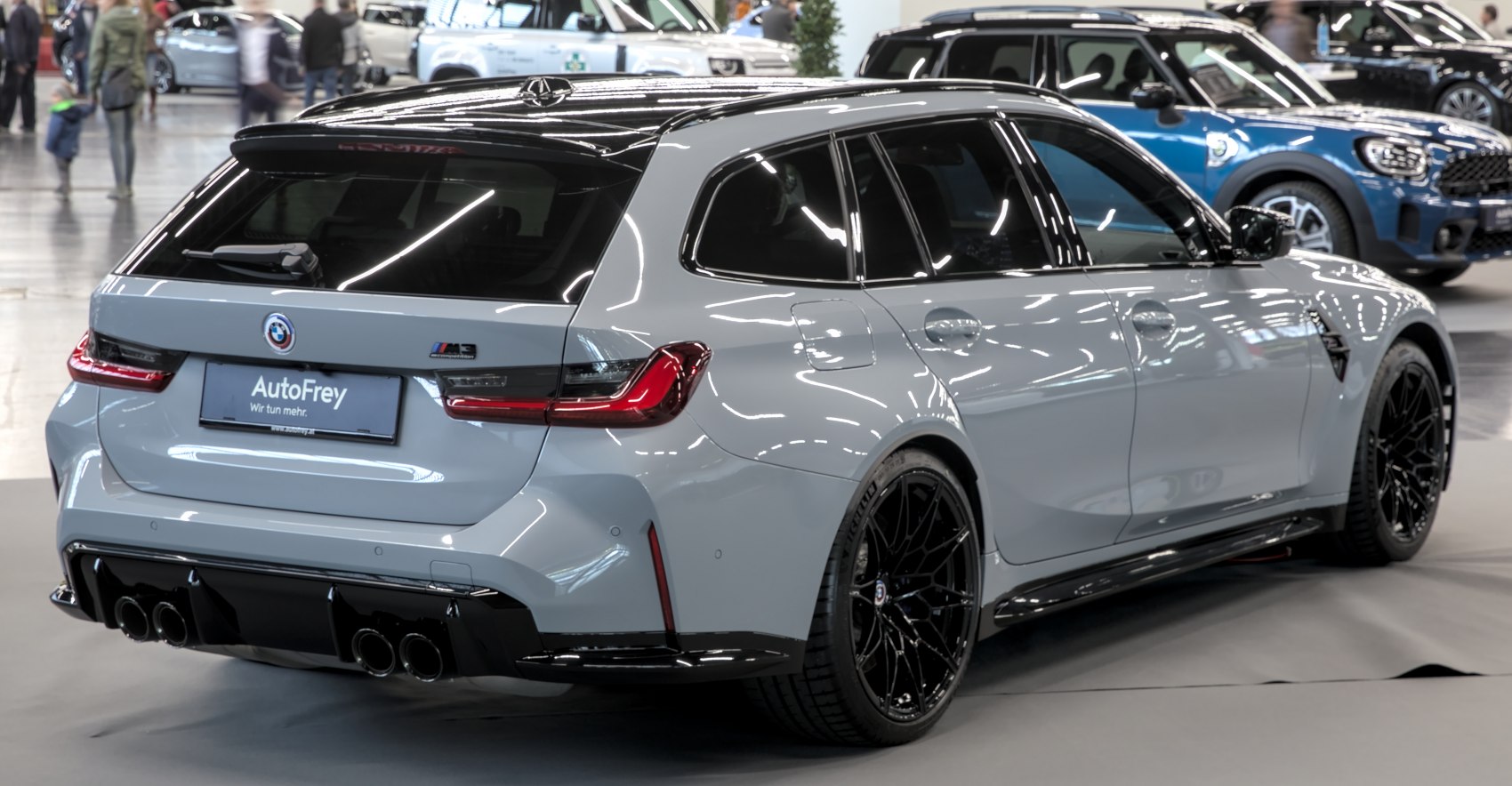 Rear view of sporty estate with quad exhausts and black wheels