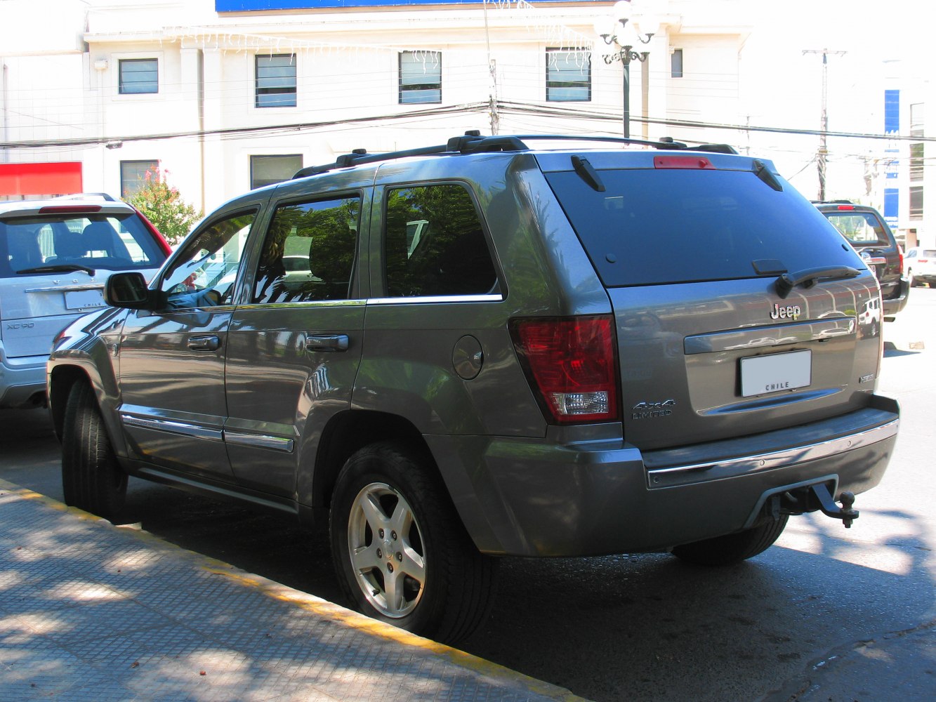 Rear side view of SUV with tinted windows and tow hitch