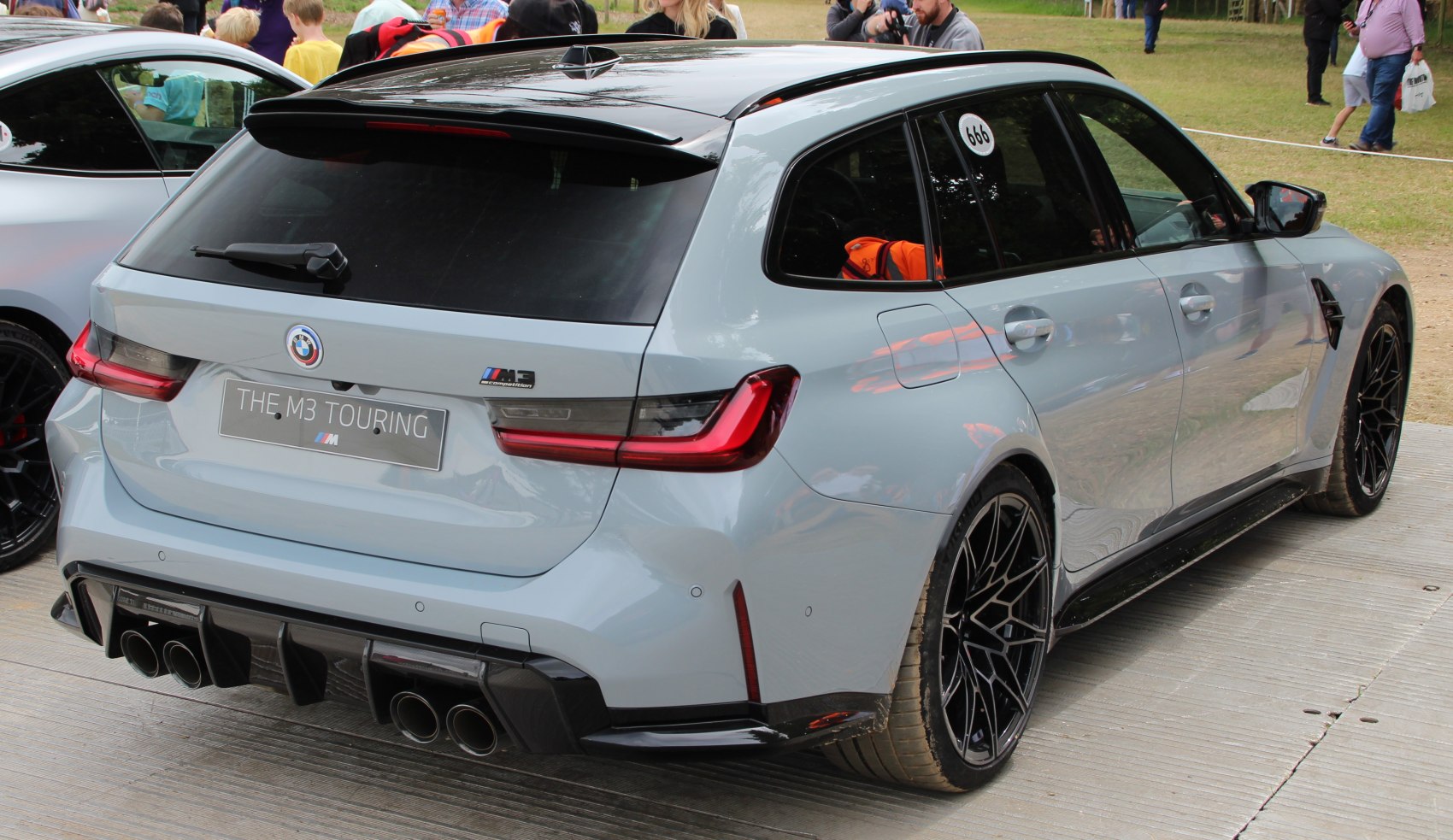 Rear view of sporty wagon featuring quad exhaust and diffuser