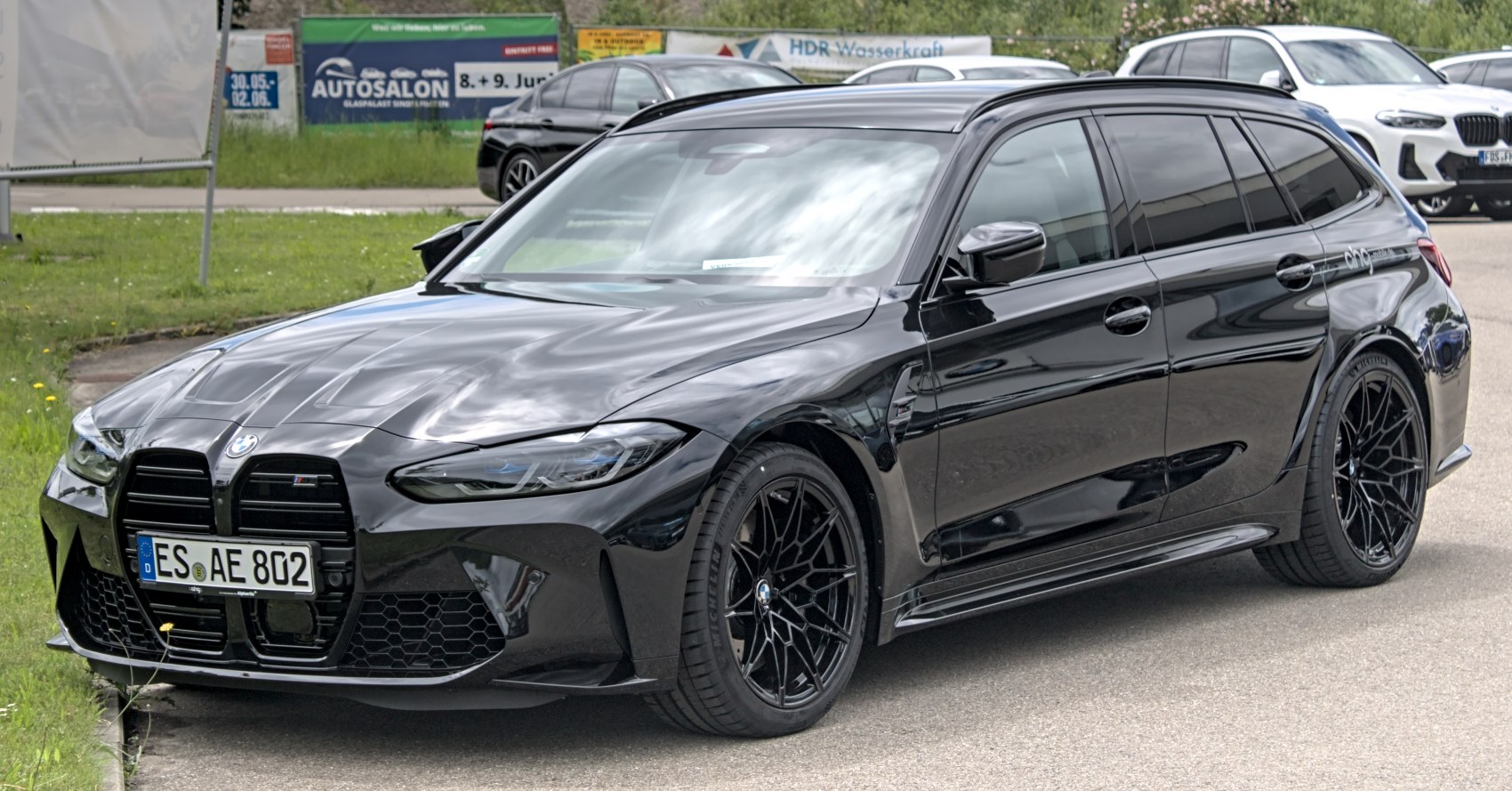 Black performance wagon with large kidney grille and sporty alloy wheels