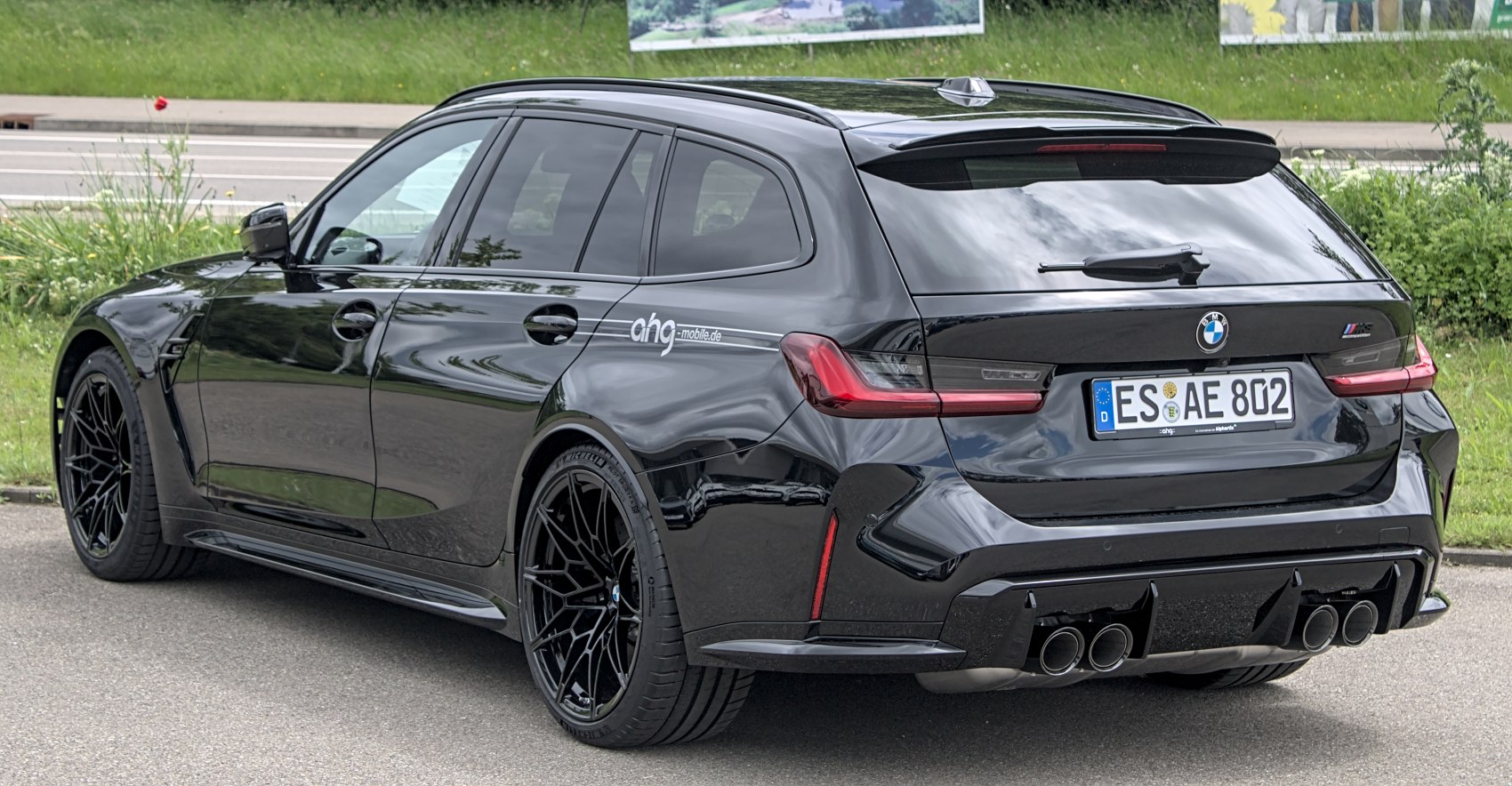 Black sports wagon with quad exhaust and aerodynamic design