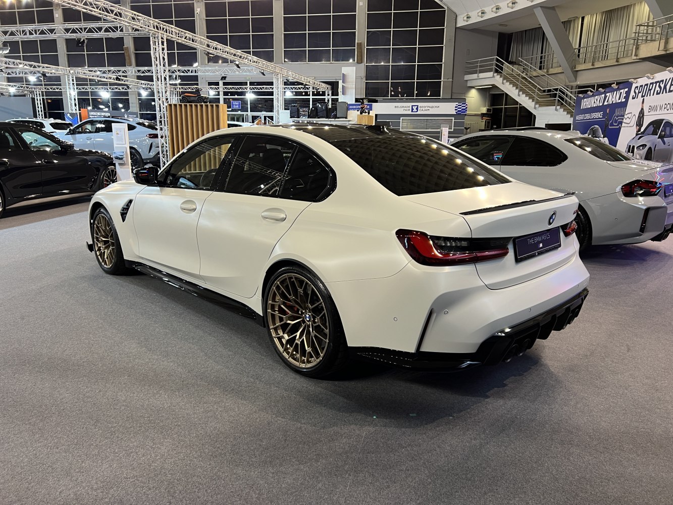 Rear-side view with bronze multi-spoke wheels and rear spoiler